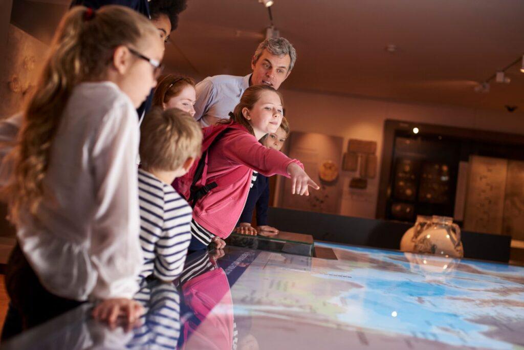 Schuelergruppe entdeckt interaktive Ausstellung im Museum waehrend einer Klassenfahrt Hamburg